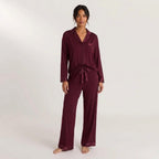 Stay In Society deep burgundy pajama set with long sleeves, notched collar, and satin piping on a female model.